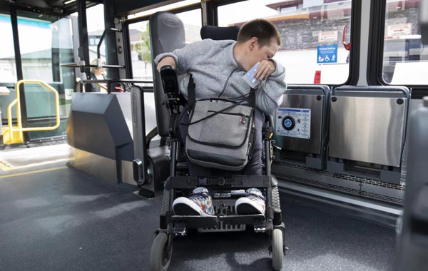 mobility passenger centers their wheelchair or scooter against the backrest of Quantum ADA securement system