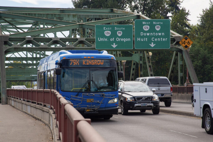 A blue city bus displaying 
