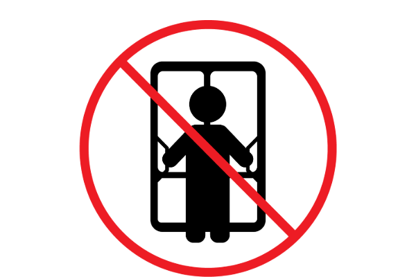 Black pictogram of a person standing in an elevator with a red prohibition circle and line over it, indicating not to use the elevator.